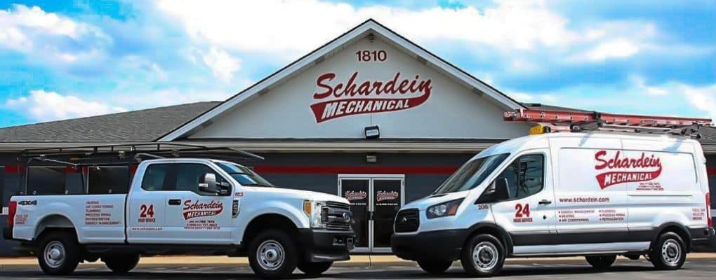 Schardein Mechanical's work vehicles parked in front of their main office.